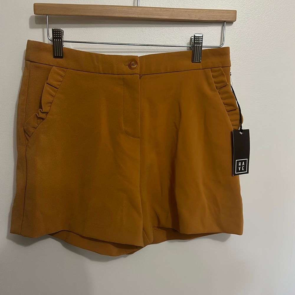 Juniors size L polyester spandex blend short in an antique gold/mustard color